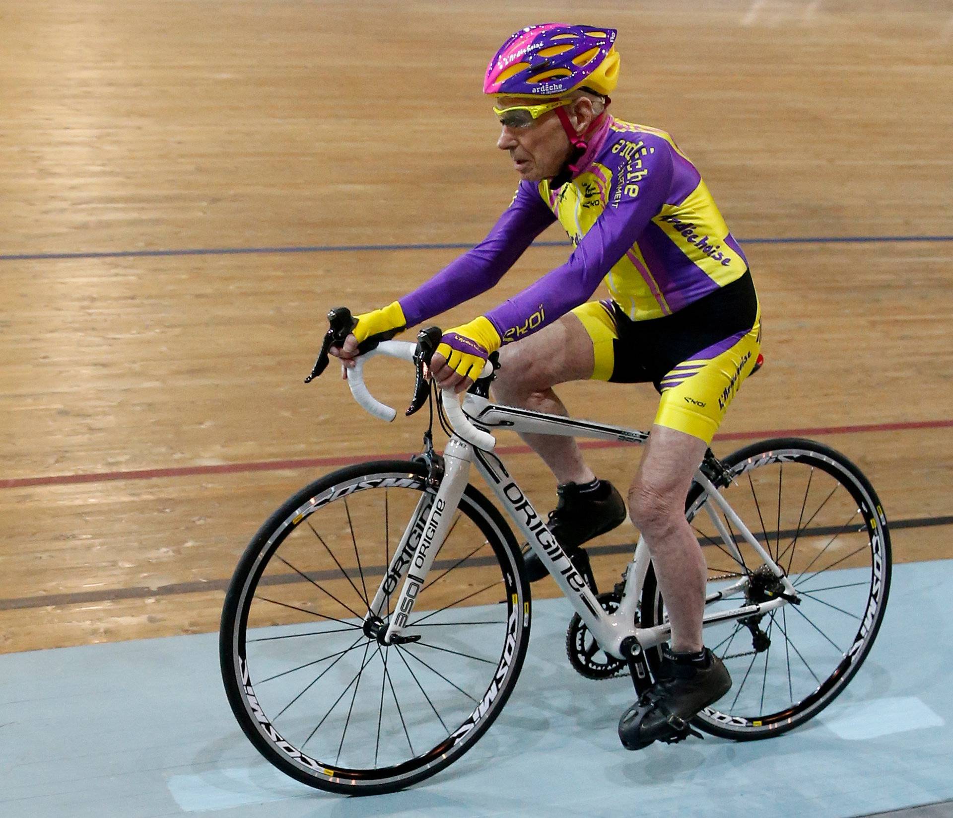 FILE PHOTO: French cyclist Robert Marchand, aged 105, rides on his way to cover 22.528 km (14.08 miles) in one hour to set a new record at the indoor Velodrome National in Montigny-les-Bretonneux