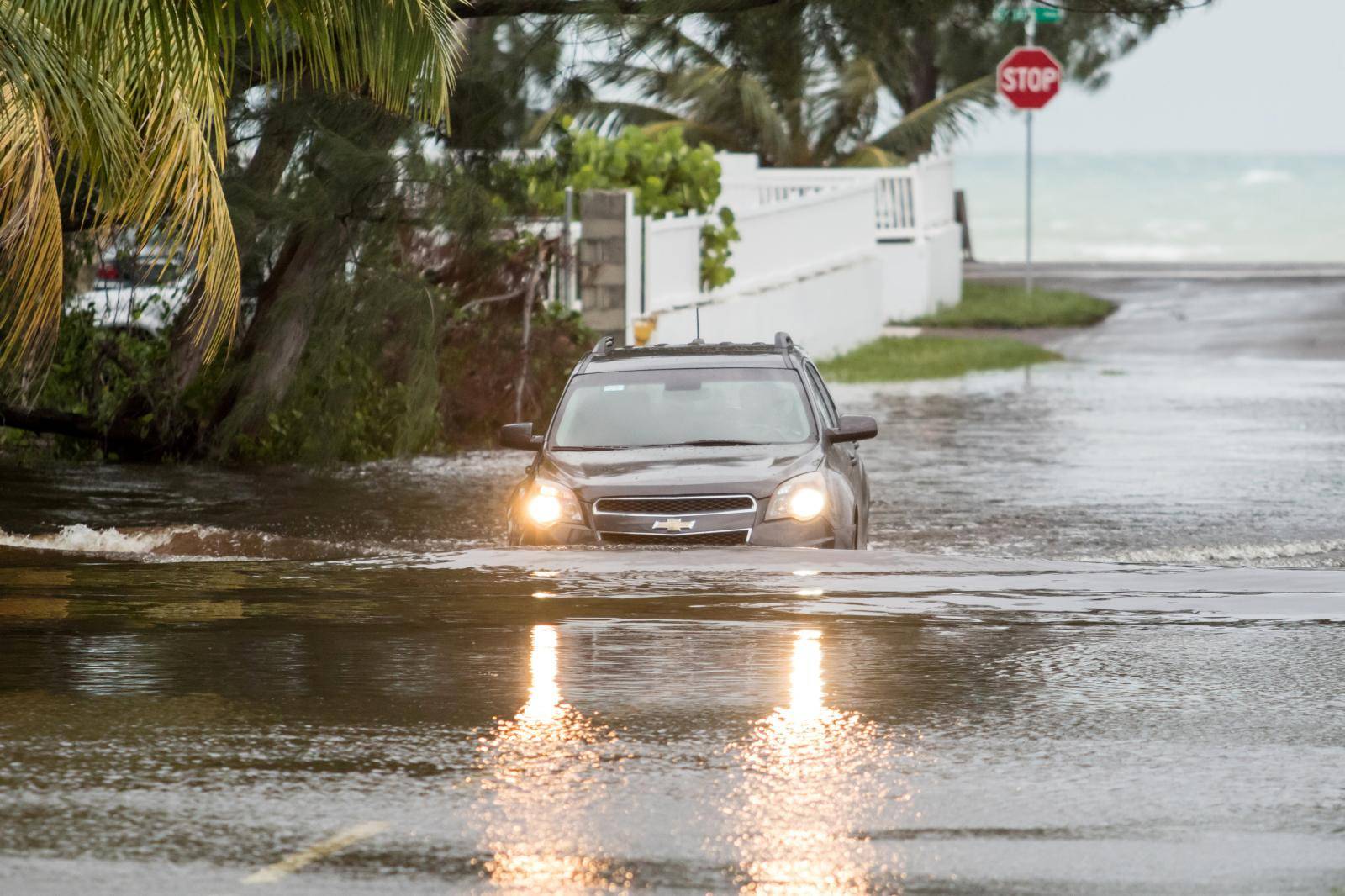 A car drives through a flooded street after the effects of Hurricane Dorian arrived in Nassau