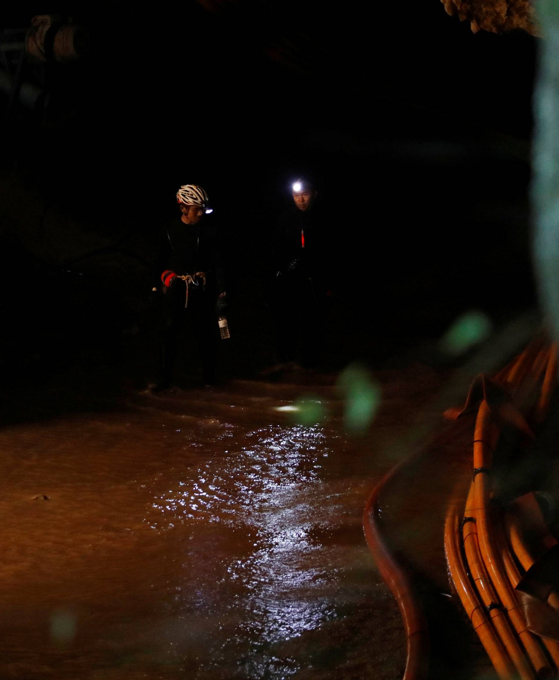 Divers walk inside Tham Luang cave complex in the northern province of Chiang Rai