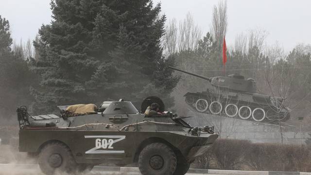 Russian Army military vehicle drives along a street in Armyansk