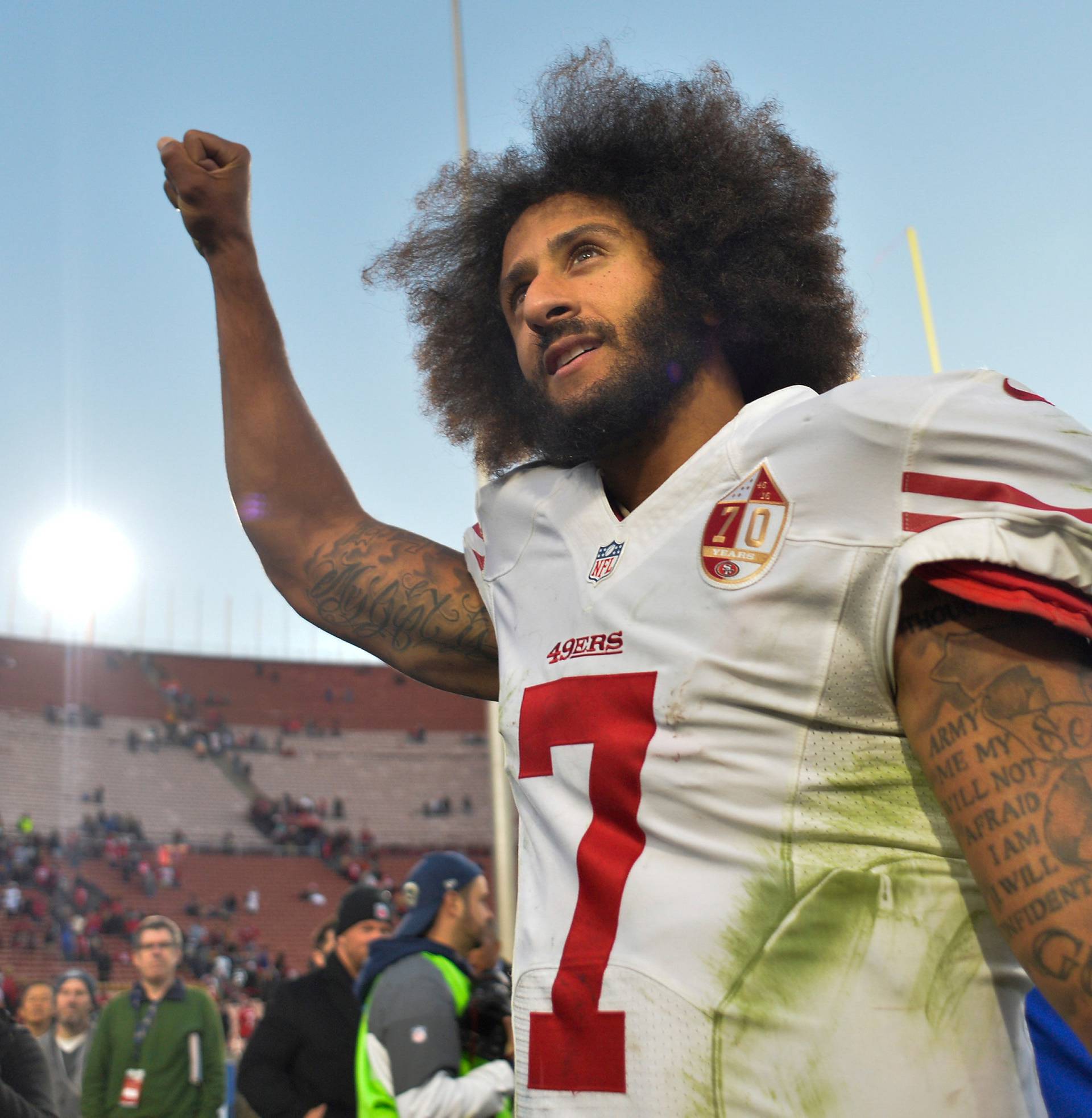 FILE PHOTO - Colin Kaepernick pumps his fist as he acknowledges the cheers at Los Angeles Memorial Coliseum in Los Angeles