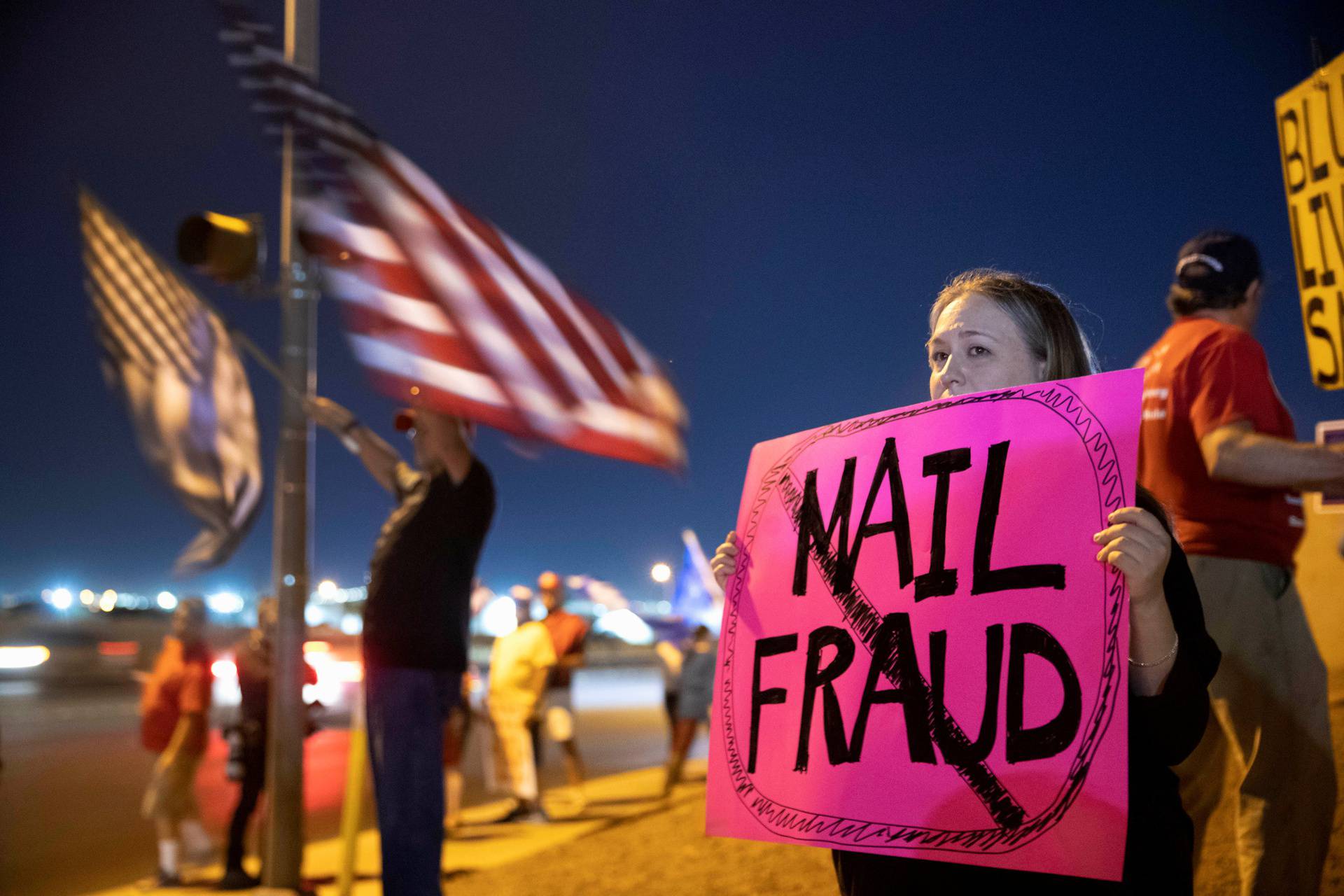 Meg Ross, a supporter of President Donald Trump, holds a sign during a "Stop the Steal" protest at the Clark County Election Center in North Las Vegas