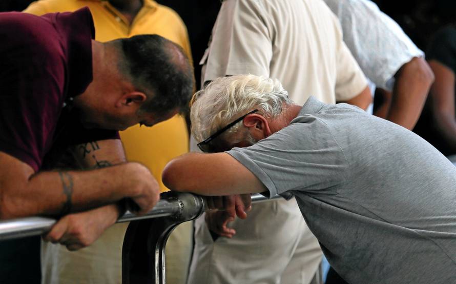 Foreign relatives of a victim of the explosion react at the police mortuary in Colombo