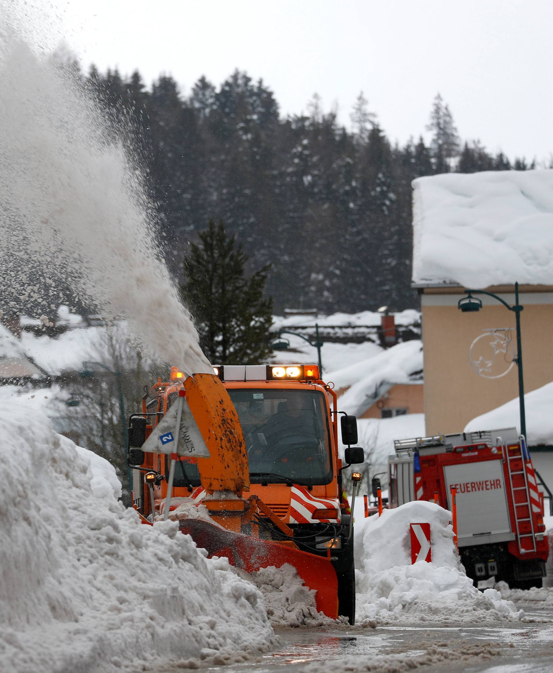 A vehicle removes snow on a road after heavy snowfall in Rosenau