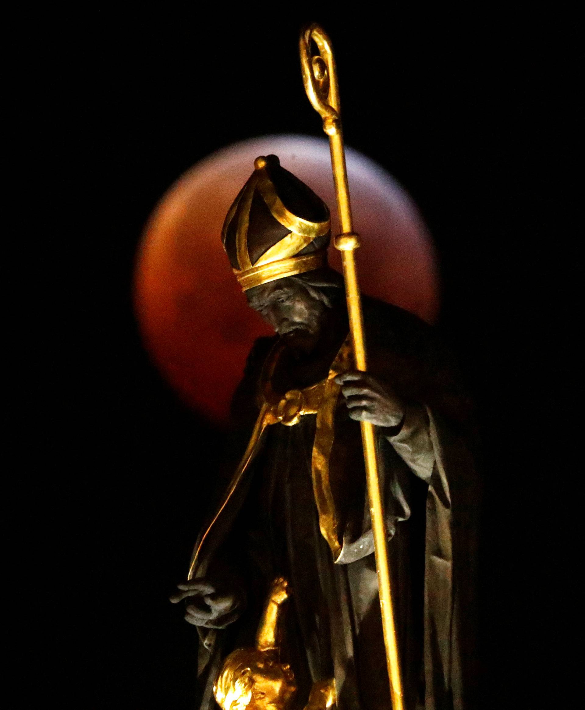 The "Super Blood Wolf Moon" is seen during a lunar eclipse on Brussels' Grand Place