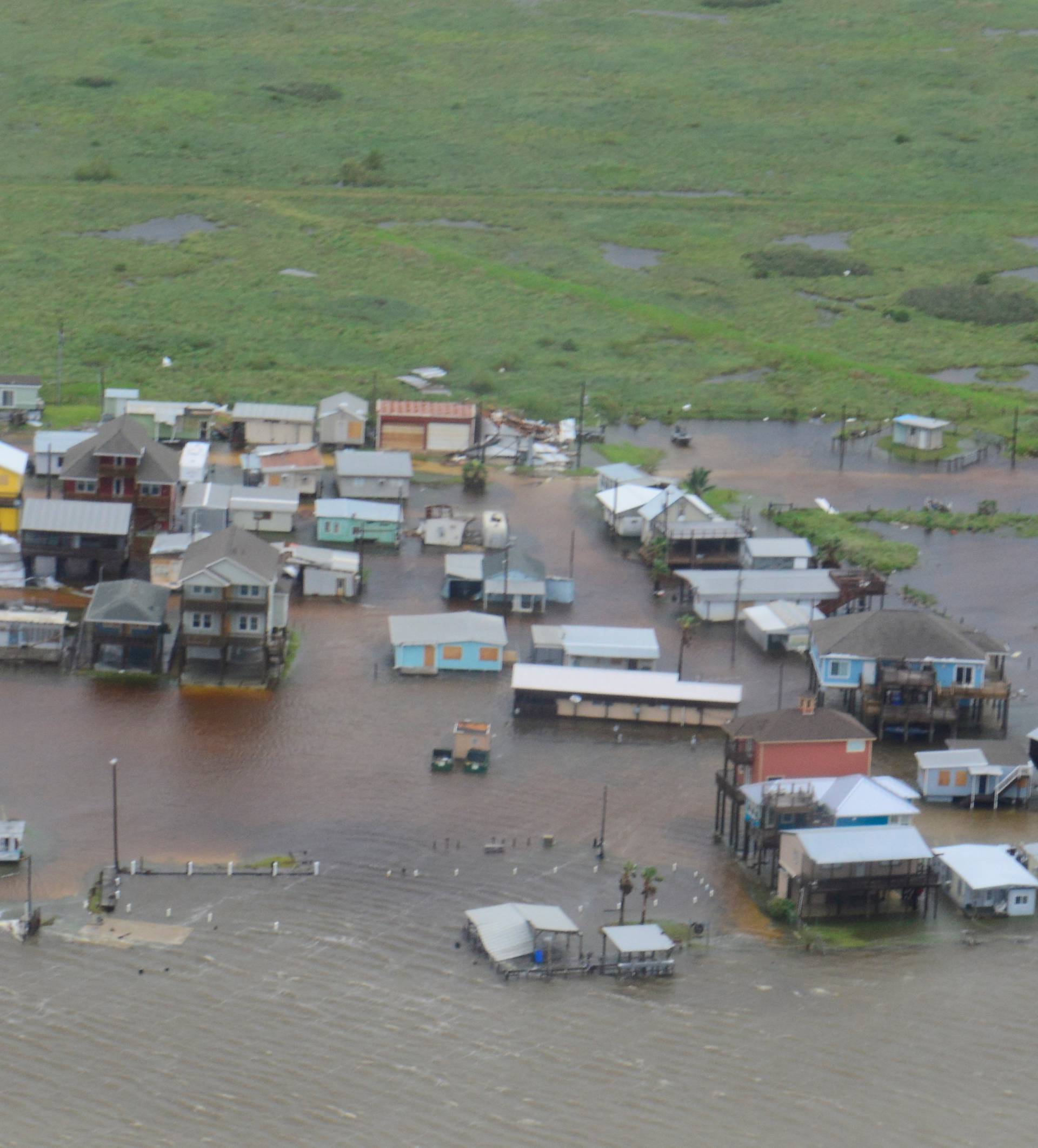 Housing surrounded by flood waters is seen from a U.S. Coast Guard helicopter during an overflight from Port Aransas to Port O'Connor