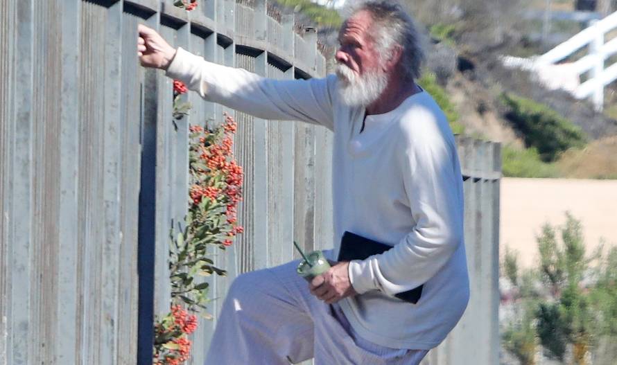 *EXCLUSIVE* Nick Nolte climbs a fence in his PJ's in Malibu