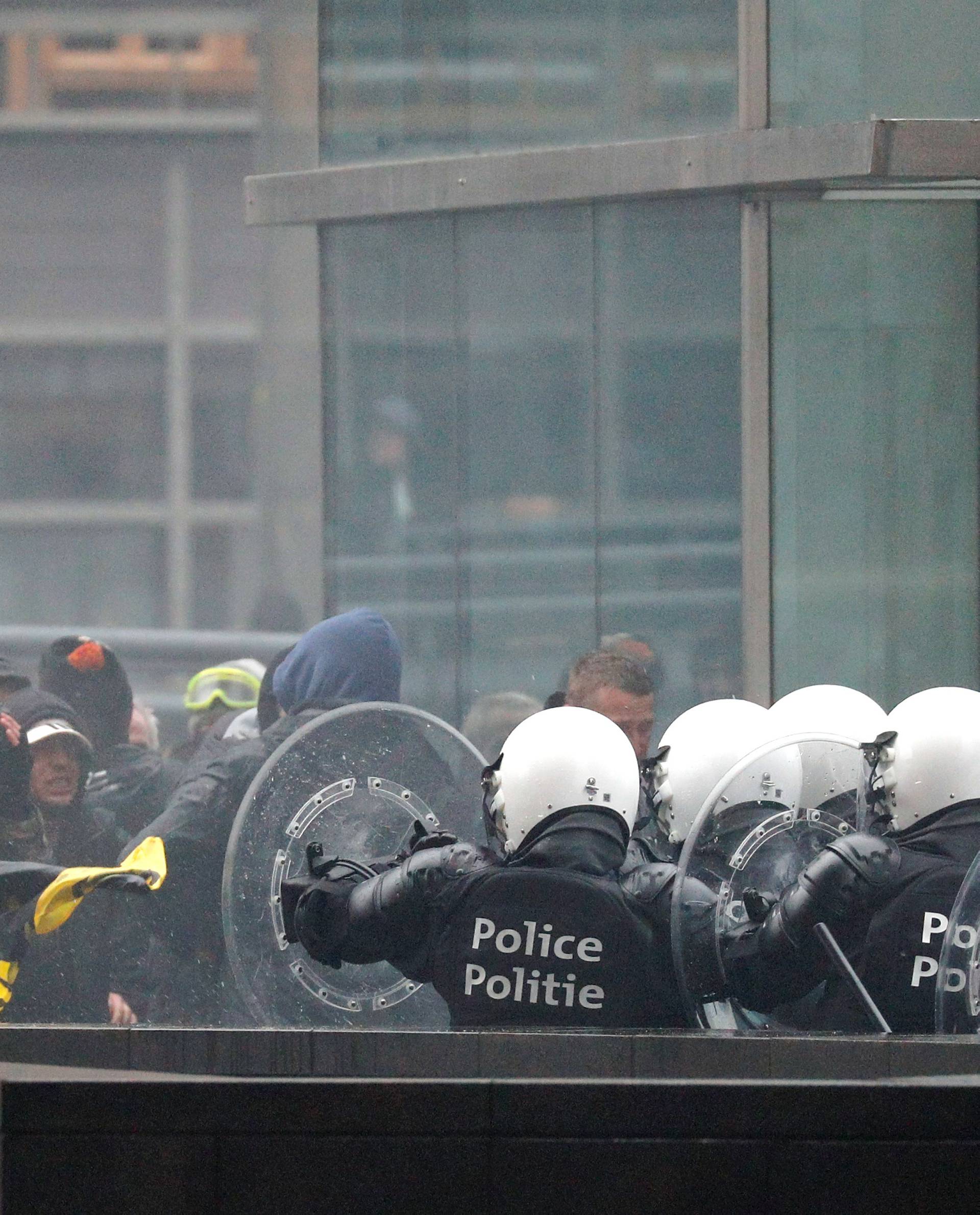 Police officers face off with far-right supporters during a protest against Marrakesh Migration Pact, outside European Commission headquarters, in Brussels