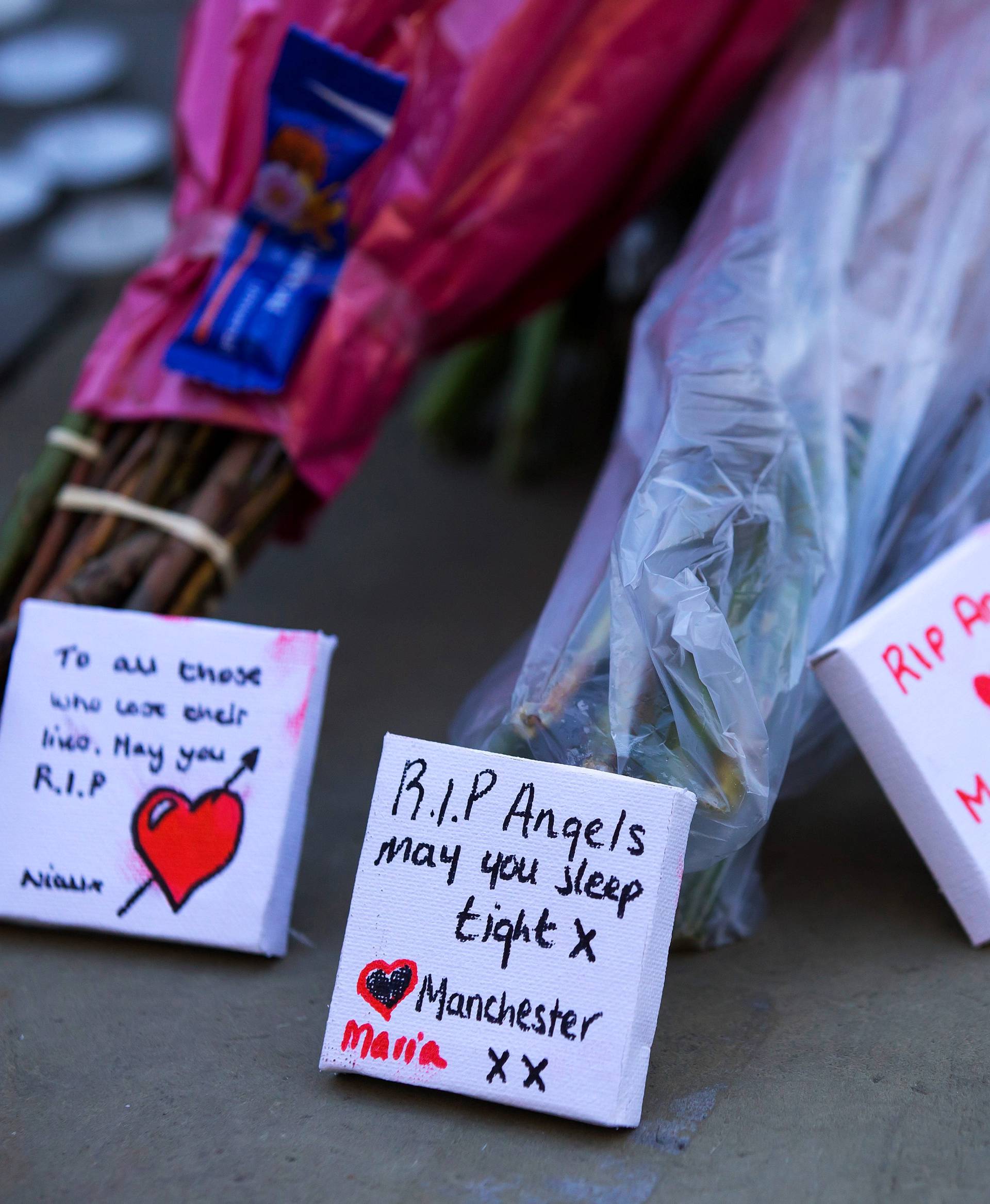 Flowers and messages of condolence are left for the victims of the Manchester Arena attack in central Manchester