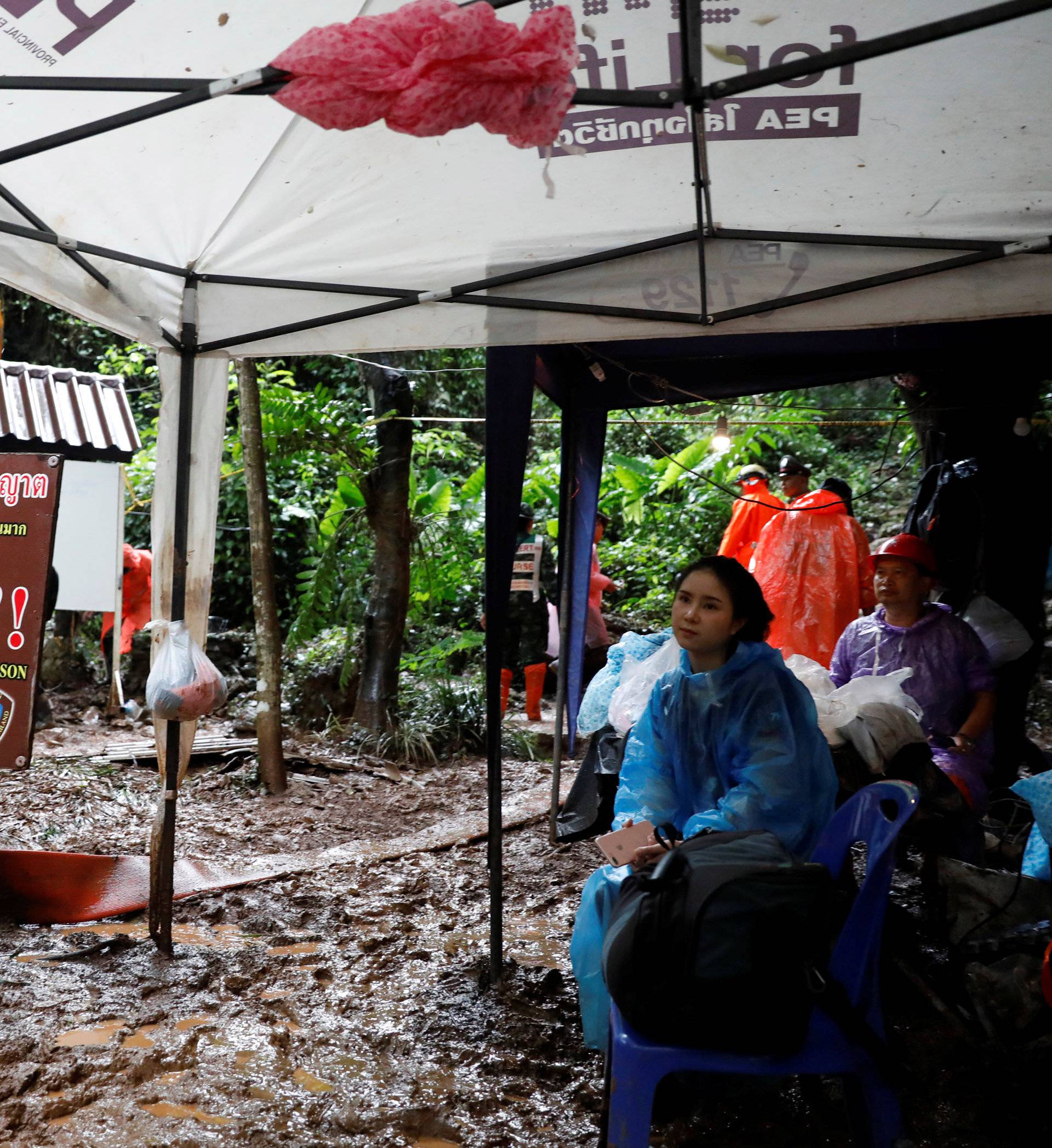 Rescue workers are seen near Tham Luang cave complex during a search for members of an under-16 soccer team and their coach, in the northern province of Chiang Rai