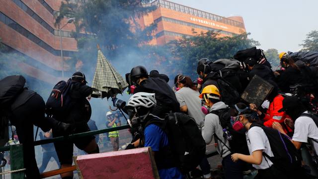 Protesters are detained by riot police while attempting to leave the campus of Hong Kong Polytechnic University (PolyU) during clashes with police in Hong Kong
