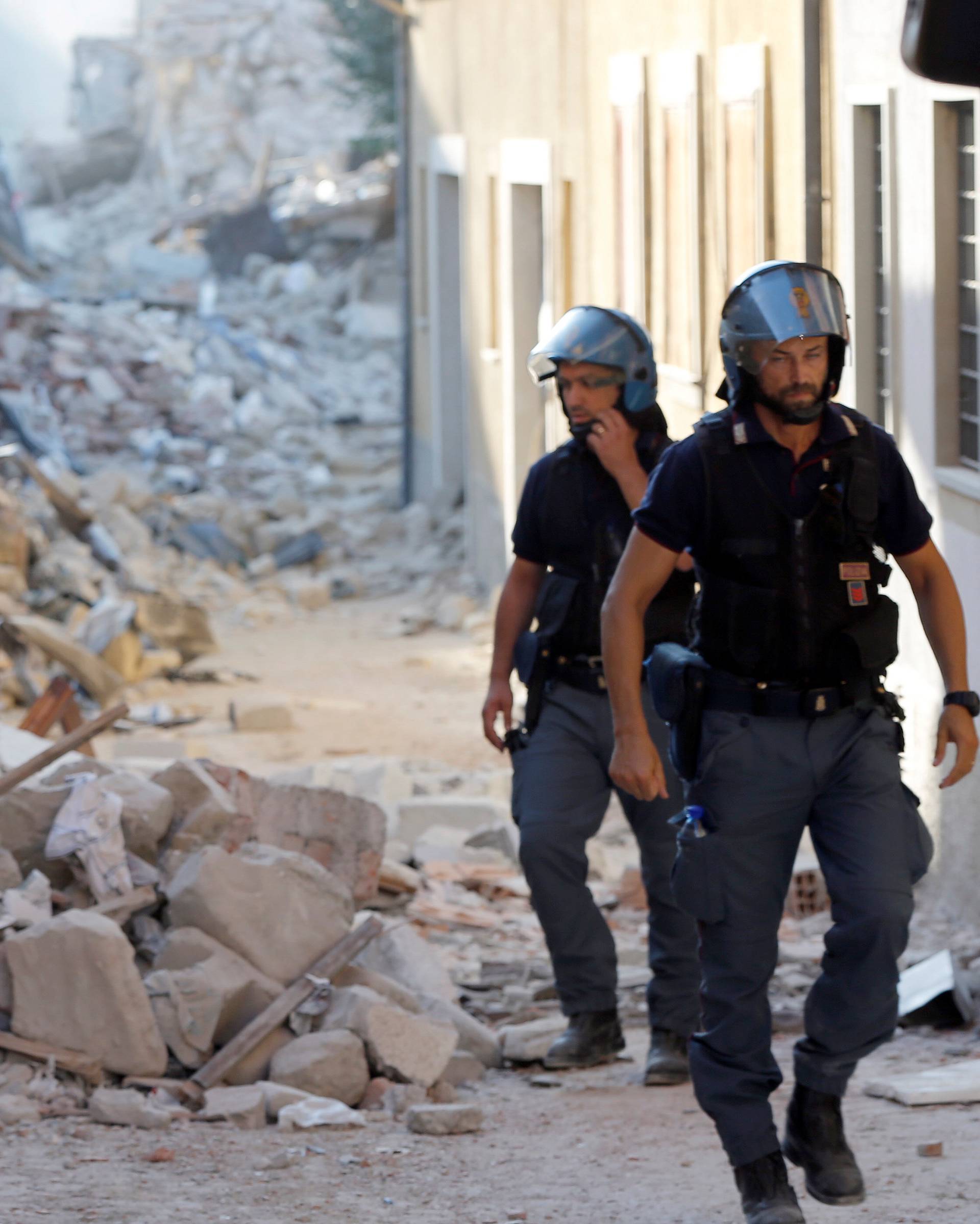 Italian Police patrol along a street following an earthquake in Amatrice