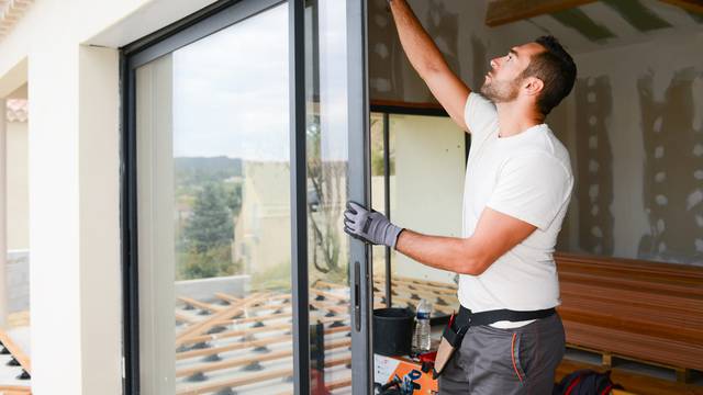 Handsome,Young,Man,Installing,Bay,Window,In,A,New,House