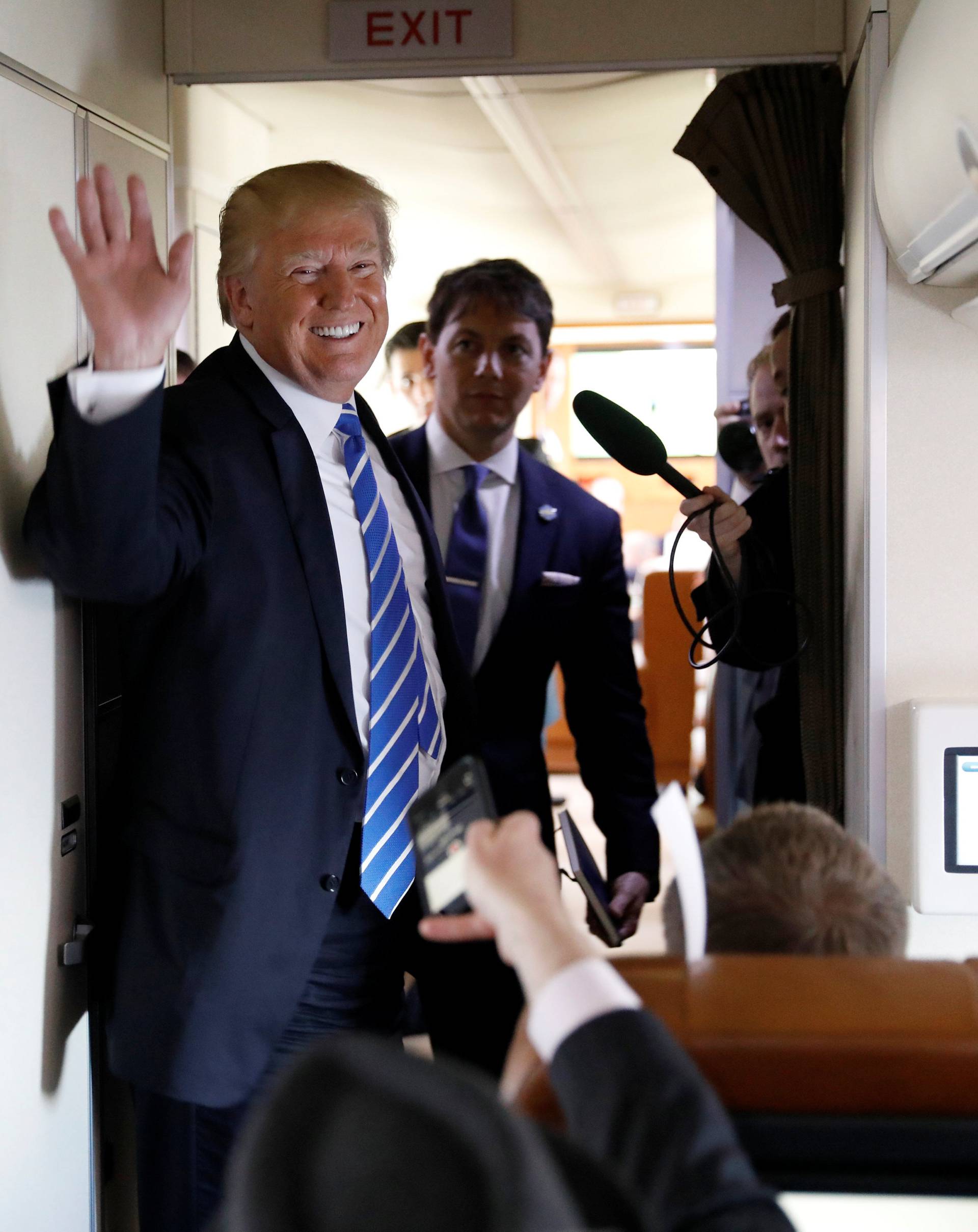 U.S. President Donald Trump speaks aboard Air Force One