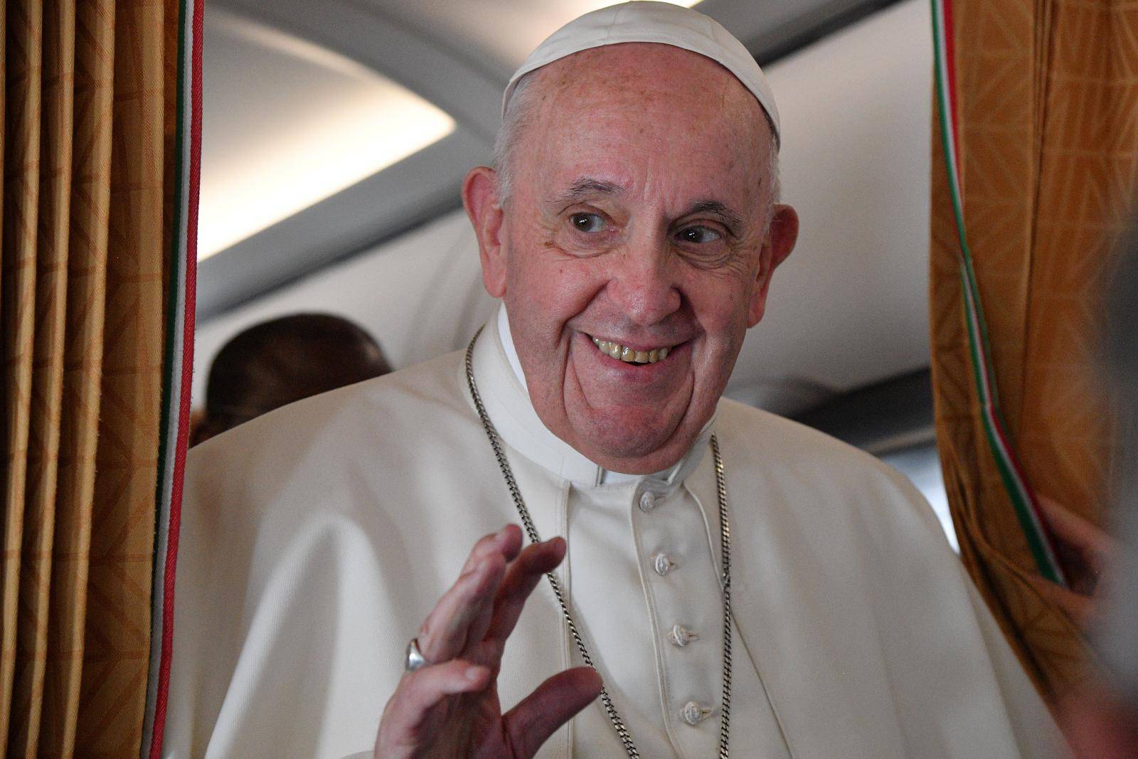 Pope Francis speaks to the media on board an Alitalia aircraft