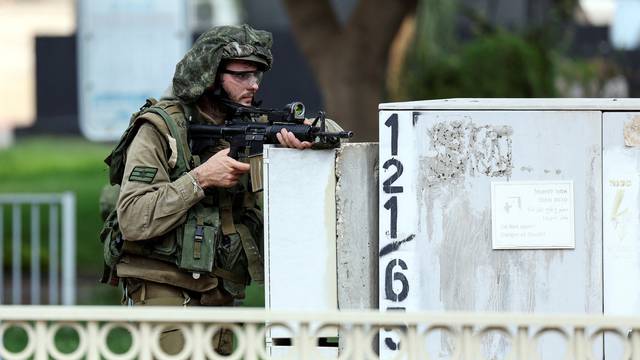 An Israeli soldier stands in position, following a mass-infiltration by Hamas gunmen from the Gaza Strip, in Sderot