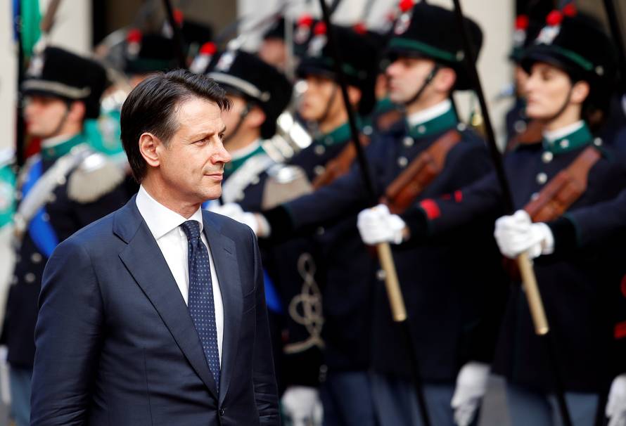 Italy's Prime Minister Giuseppe Conte reviews the guard of honour at Chigi palace in Rome