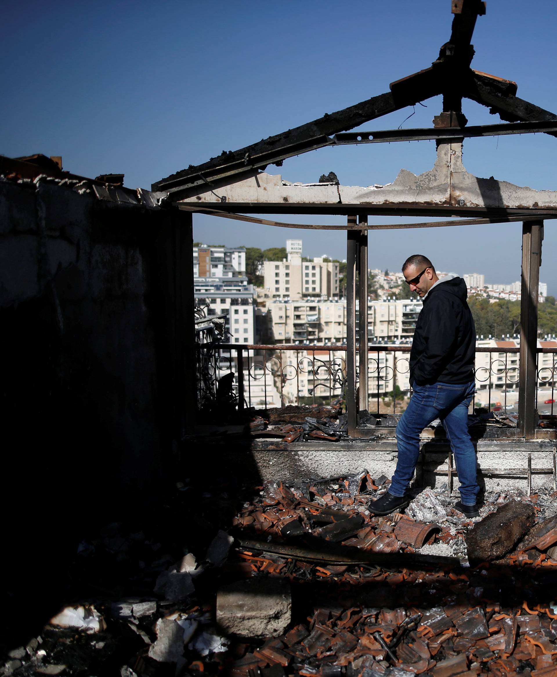 A man examines the damage caused to a house from Thursday's fire in the northern city of Haifa