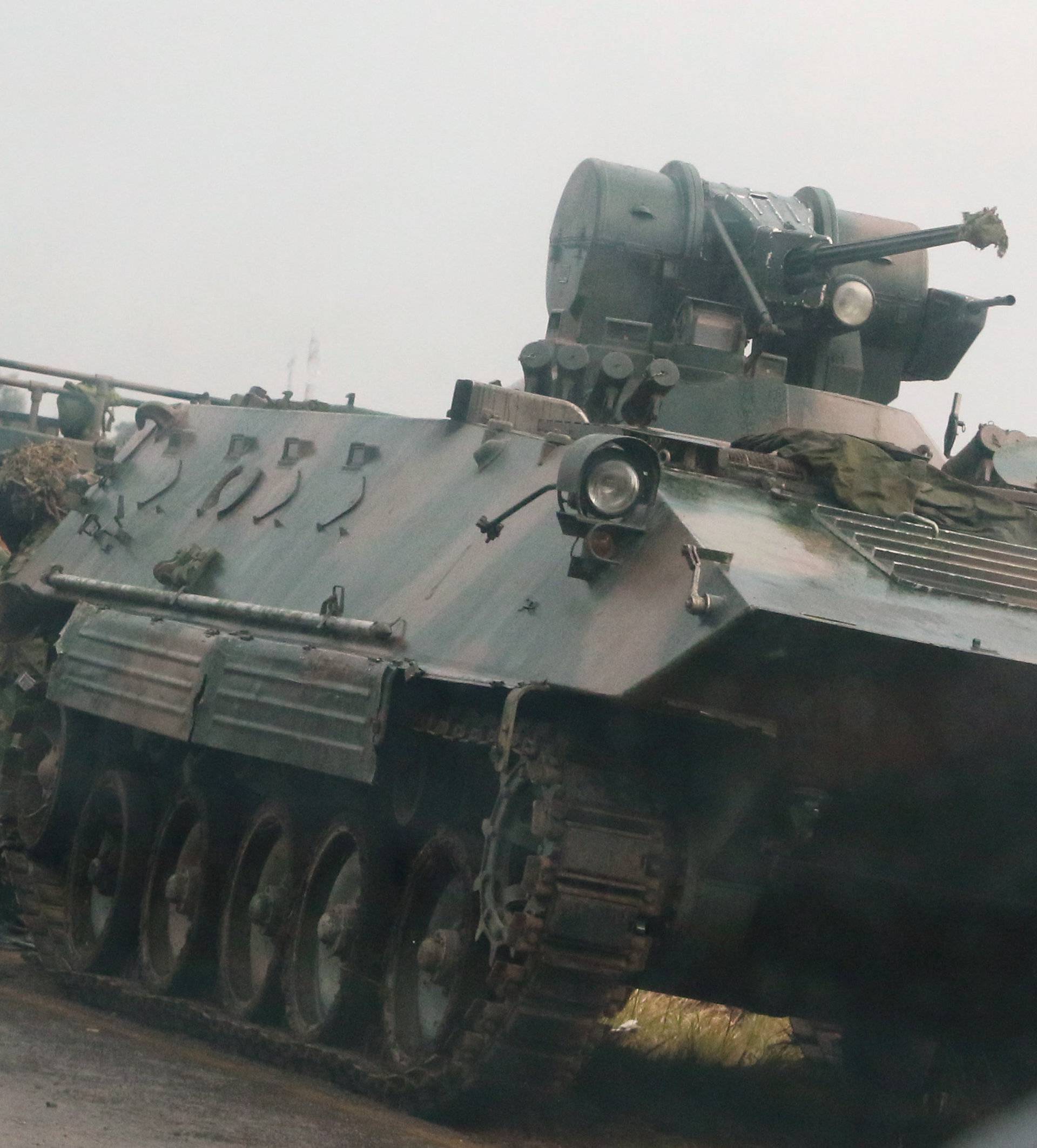 Soldiers stand beside military vehicles just outside Harare,Zimbabwe