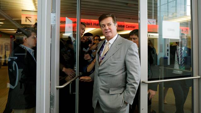 FILE PHOTO: Manafort, campaign manager to Republican Presidential Candidate Trump, escapes a mob of reporters asking about the Republican National Convention Committee on Rules in Cleveland