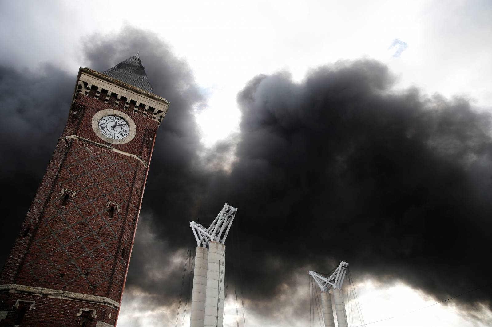 Plumes of smoke rise in the sky after a large fire broke out at the factory of Lubrizol in Rouen