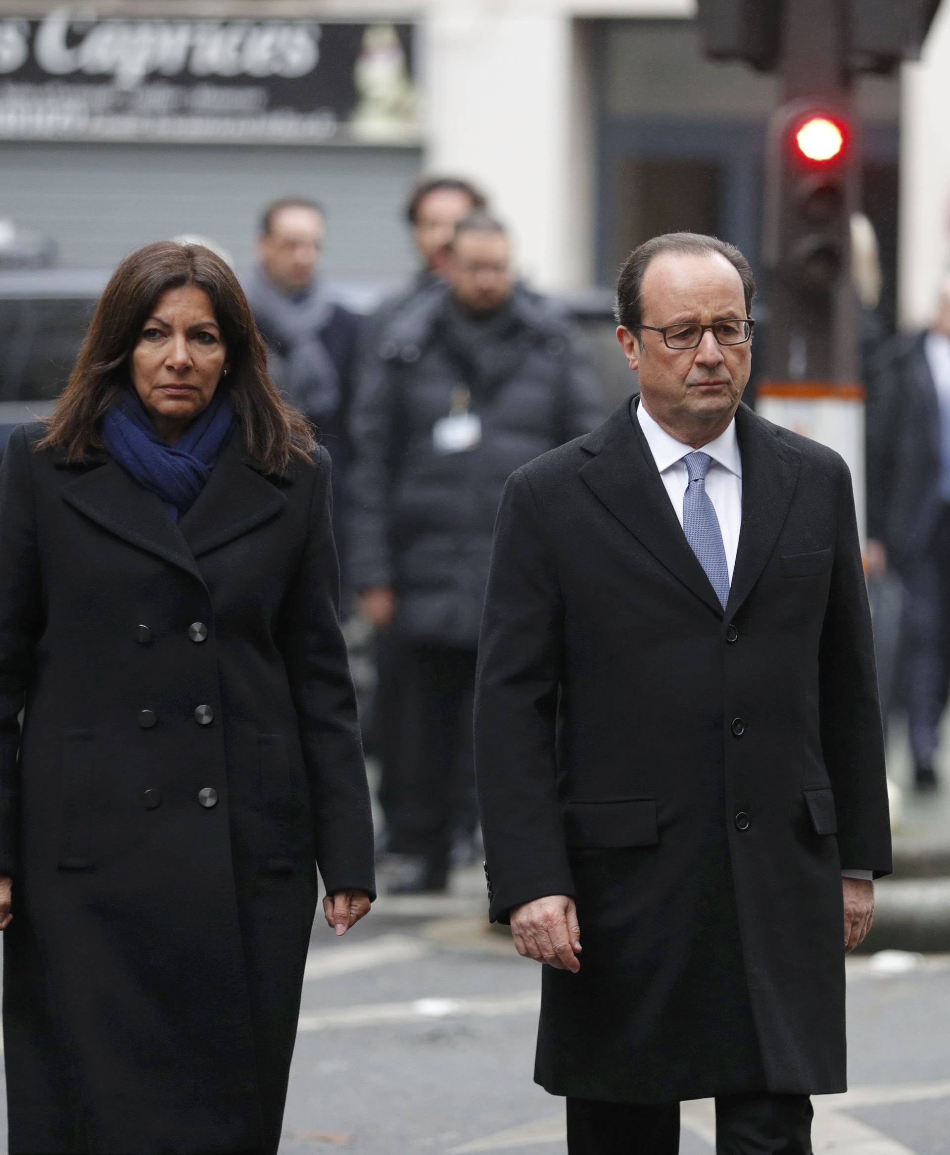 French President Francois Hollande and Paris Mayor Anne Hidalgo unveil a commemorative plaque next to the "La Belle Equipe" bar and restaurant in Paris