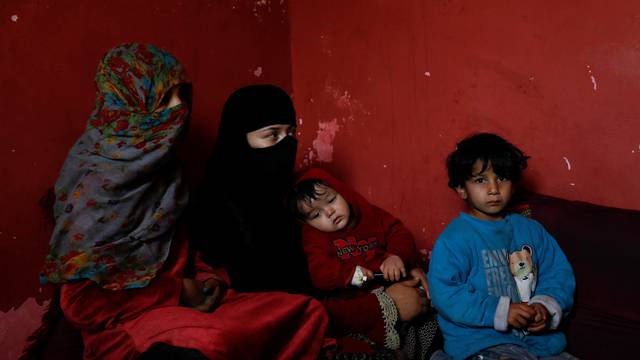Rahmat, 10 months old, and his mother are seen at their home following an increase in the number of pneumonia cases in Kabul