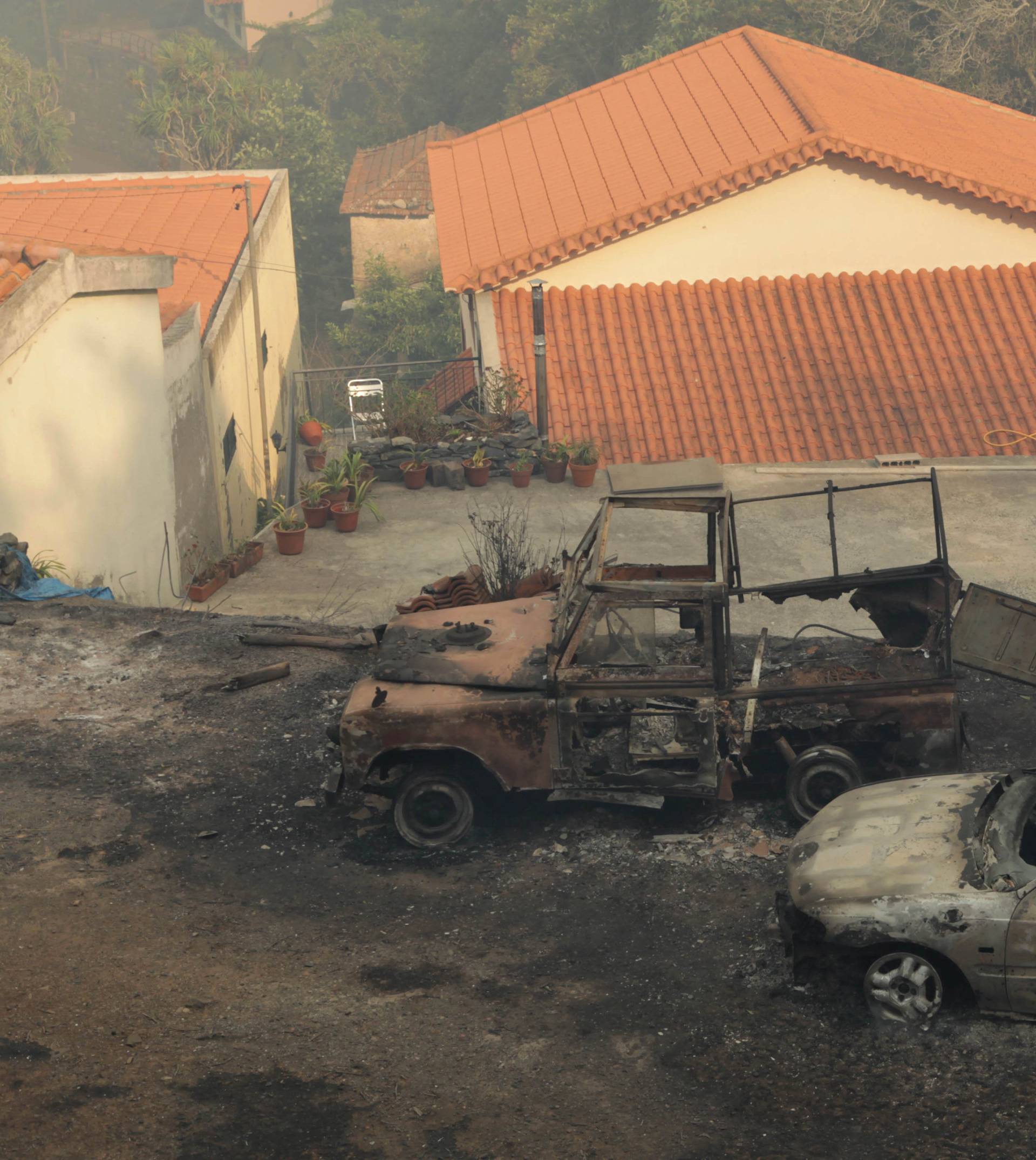 Vehicles burnt during forest fires are pictured at Caminho do Meio in Funchal