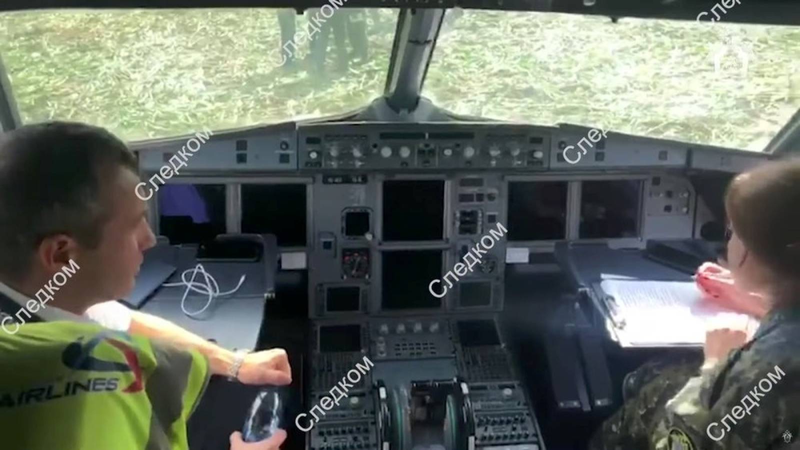A still image shows investigators working inside the cockpit of a passenger plane following an emergency landing near Moscow
