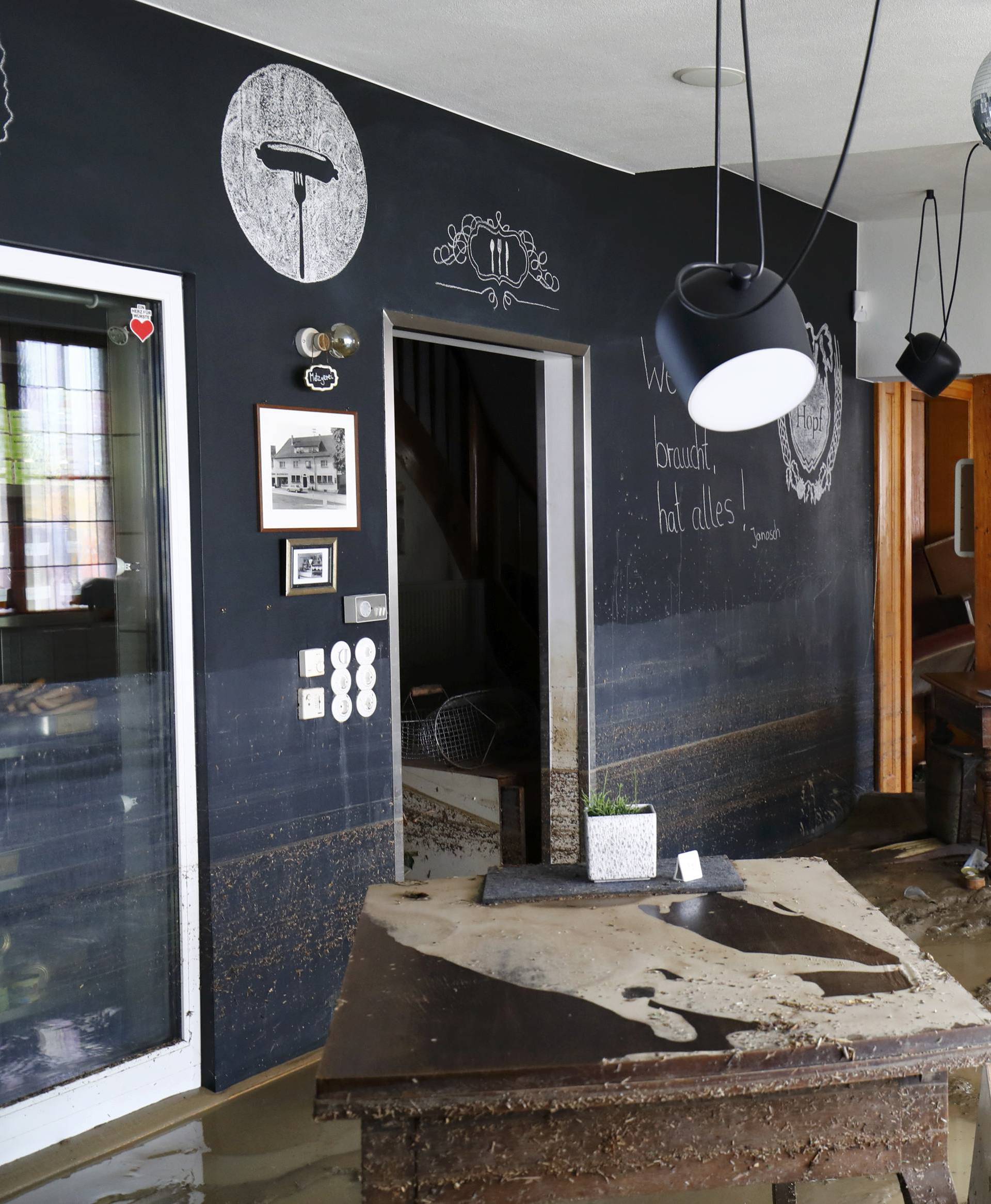 Restaurant owner Thomas Hopf stands inside his ruined location after the floods in the town of Braunsbach