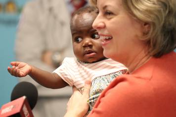 Dominique is held by Nancy Swabb during a news conference in Park Ridge