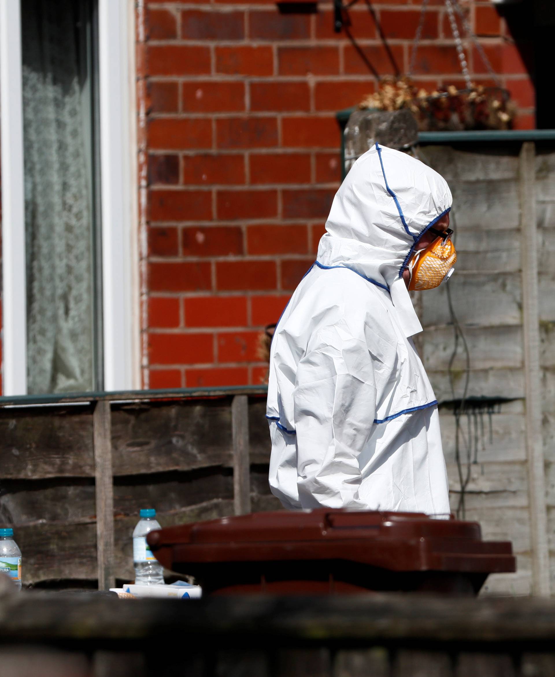 Police investigators work at residential property in south Manchester