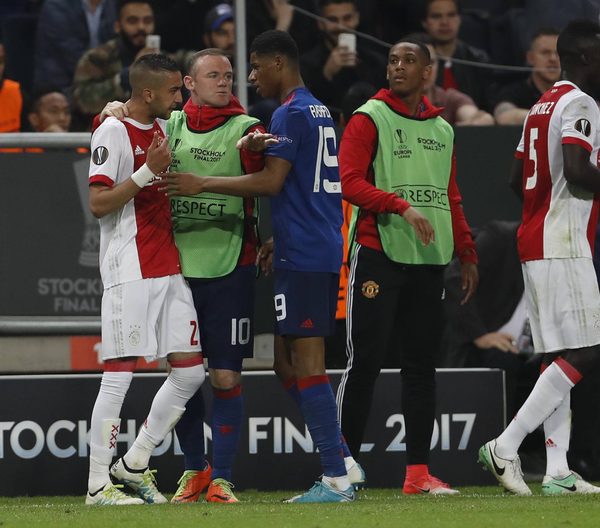 Ajax's Hakim Ziyech and Manchester United's Marcus Rashford clash as Manchester United's Wayne Rooney seperates them