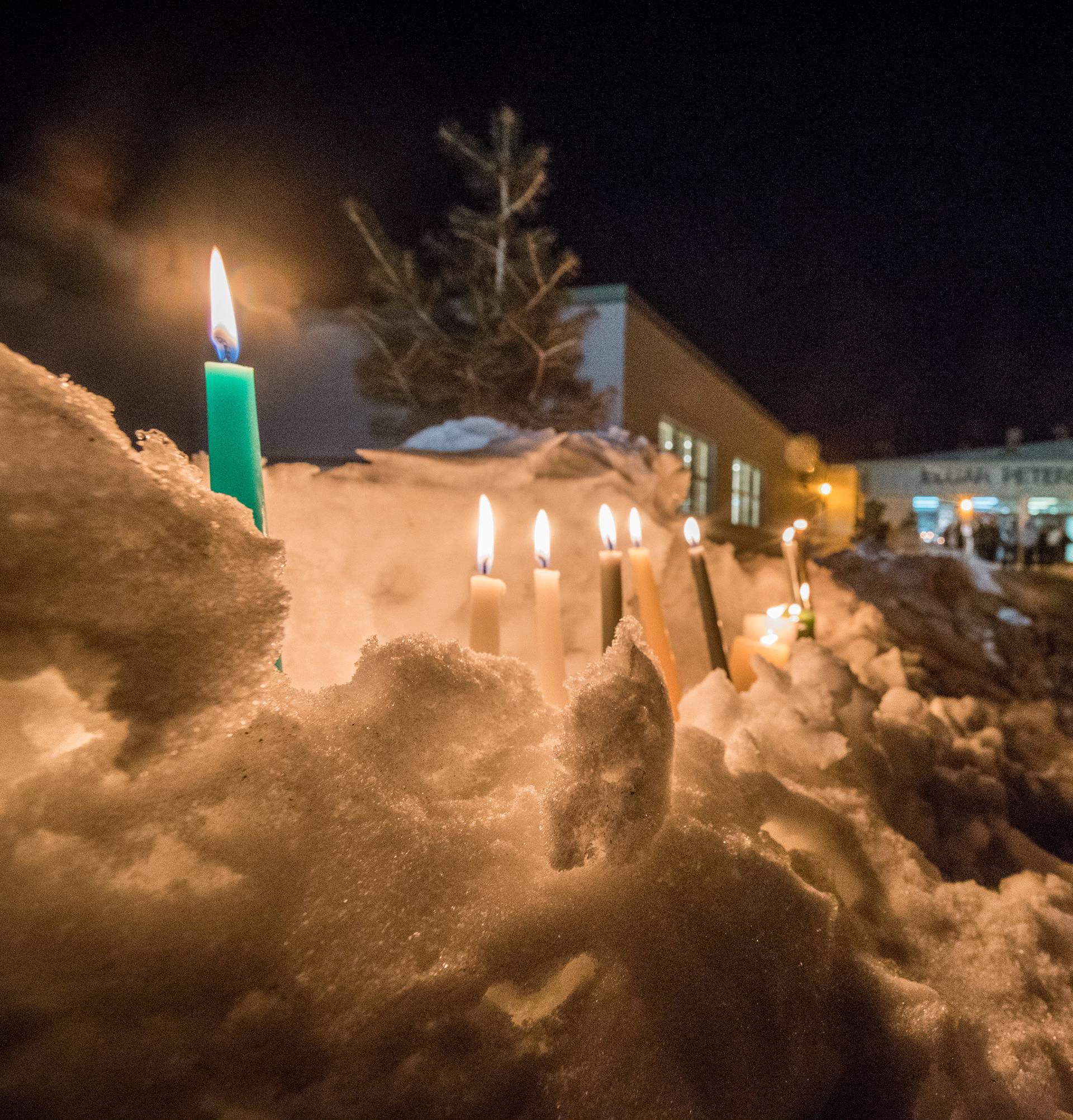 Candles burn to show support for the victims and families of a fatal bus crash is on display as members of the community leave a vigil for the Humboldt Broncos