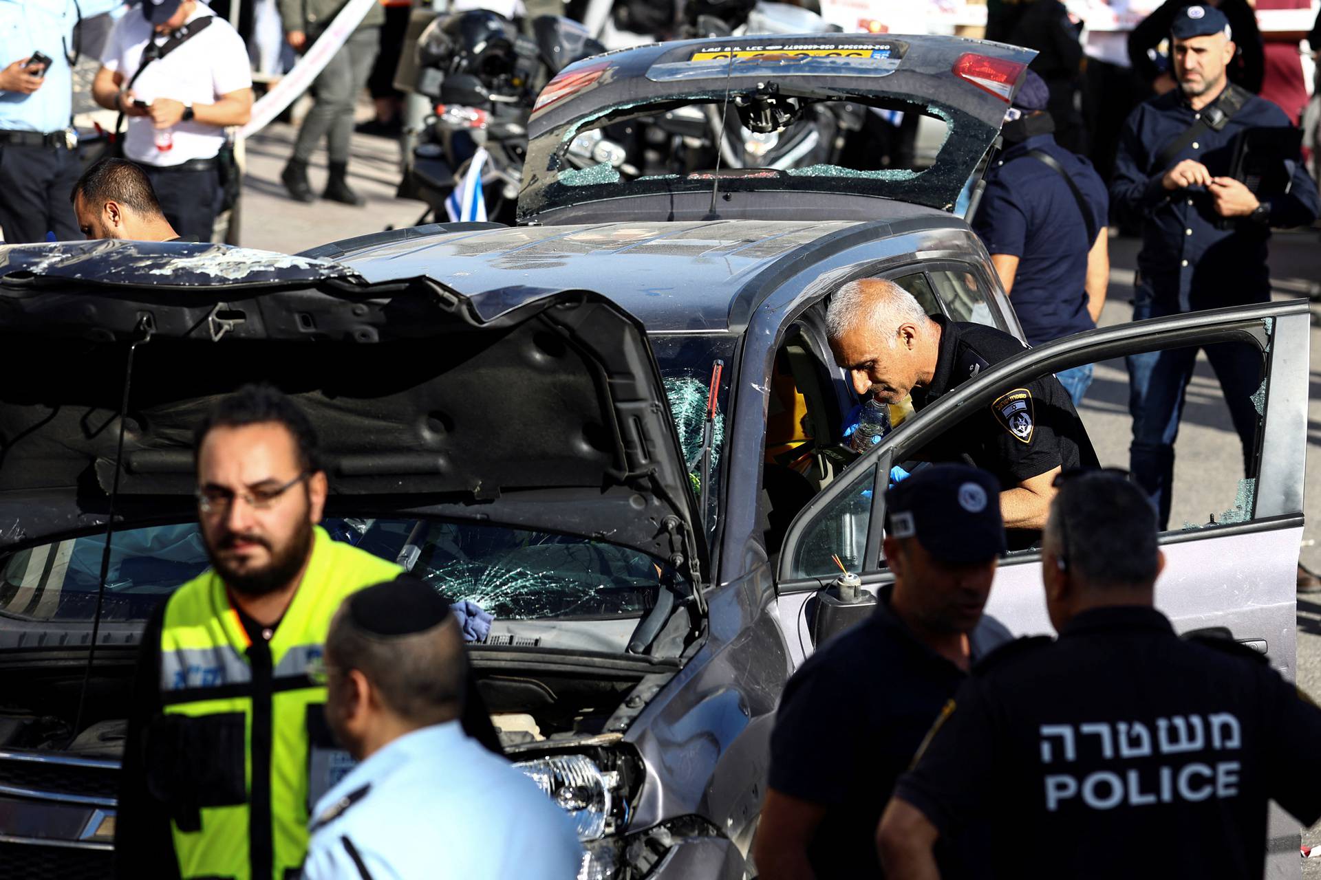 Israeli security forces and rescue workers work at the scene following an incident by Jerusalem's main market