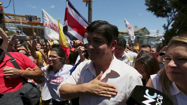 Carlos Alvarado Quesada, presidential candidate of the ruling Citizens' Action Party, gestures to supporters after casting his ballot during the presidential election in San Jose