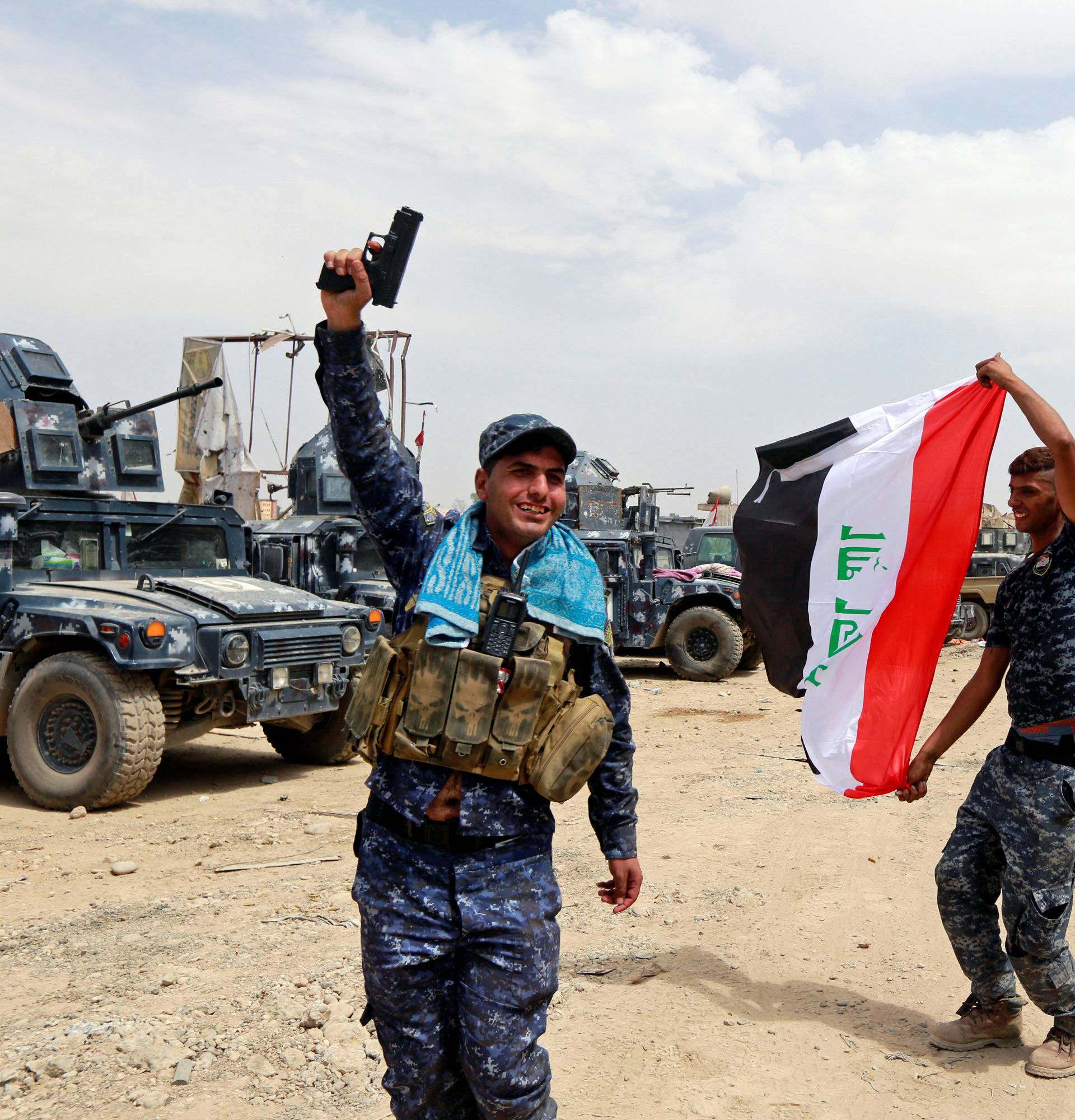 Iraqi Federal Police celebrate in the Old City of Mosul