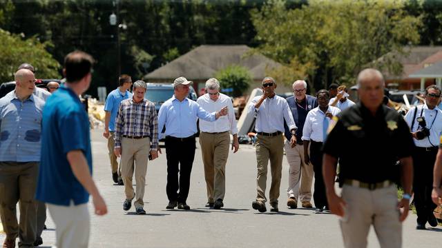 U.S. President Barack Obama tours a flood-affected neighborhood with U.S. Senator David Vitter, Louisiana Governor John Bel Edwards and U.S. Senator Bill Cassidy in Zachary