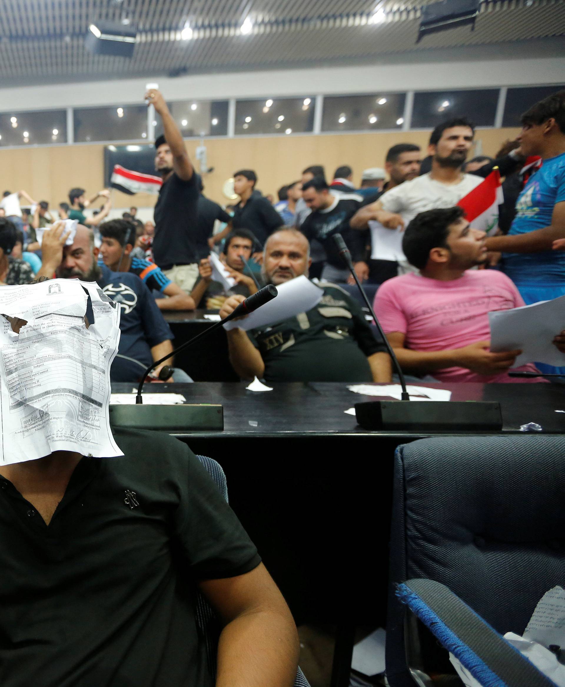 Followers of Iraq's Shi'ite cleric Moqtada al-Sadr are seen in the parliament building as they storm Baghdad's Green Zone after lawmakers failed to convene for a vote on overhauling the government, in Iraq
