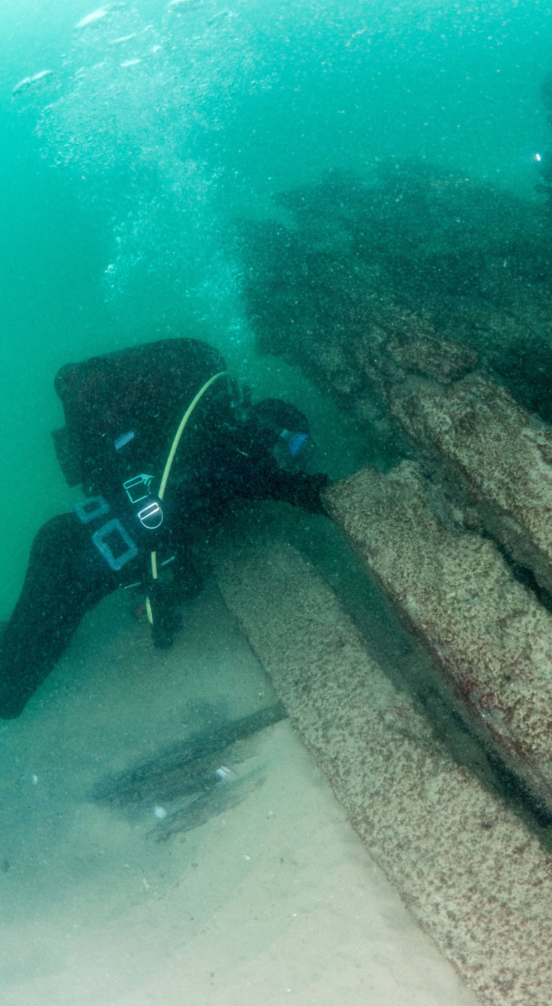 Divers are seen during the discovery of a centuries-old shipwreck, in Cascais