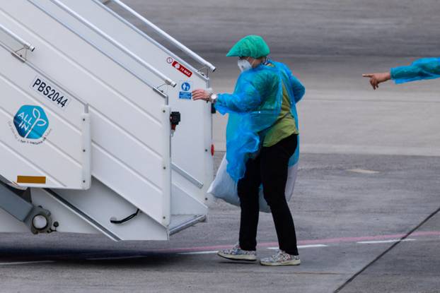 Passengers of the cruise ship MV Hondius, which was affected by a hantavirus outbreak, arrive at Tenerife Sud airport