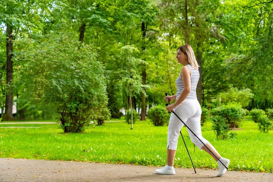 Nordic,Walking,-,Woman,Exercising,In,City,Park