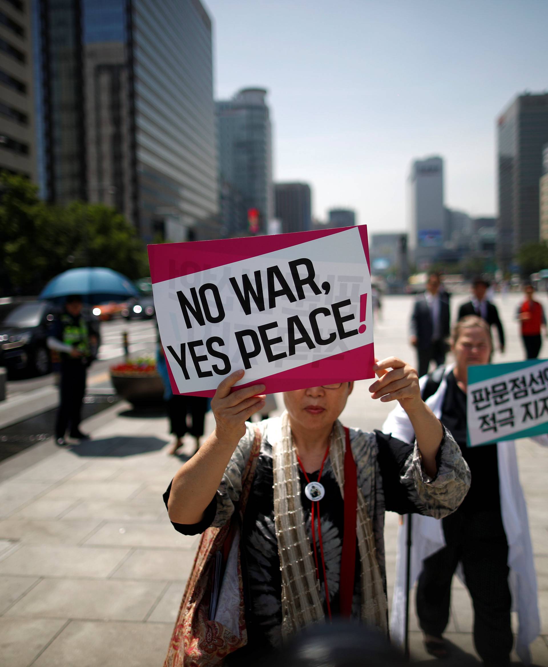 Women attend a protest against U.S. President Donald Trump near U.S. embassy in Seoul
