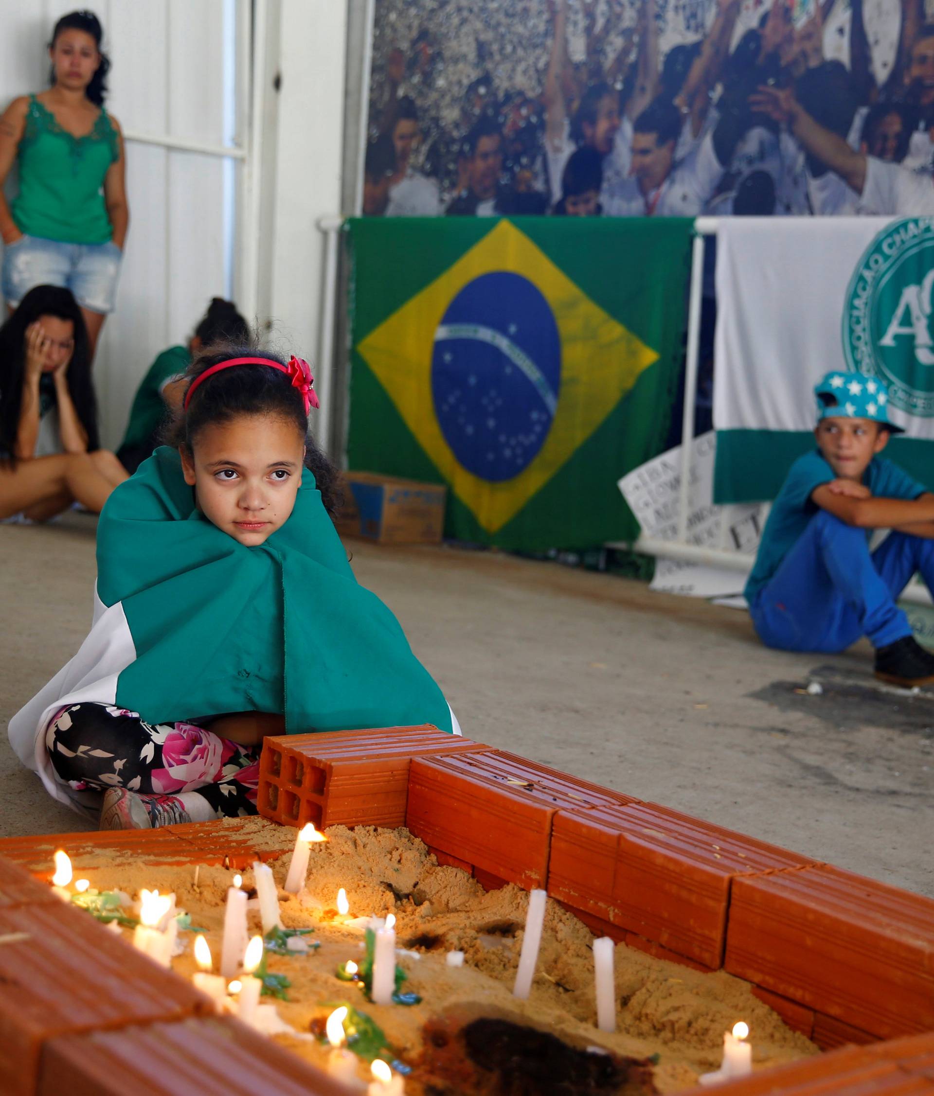 Young fans of Chapecoense soccer team pay tribute to Chapecoense's players at the Arena Conda stadium in Chapeco