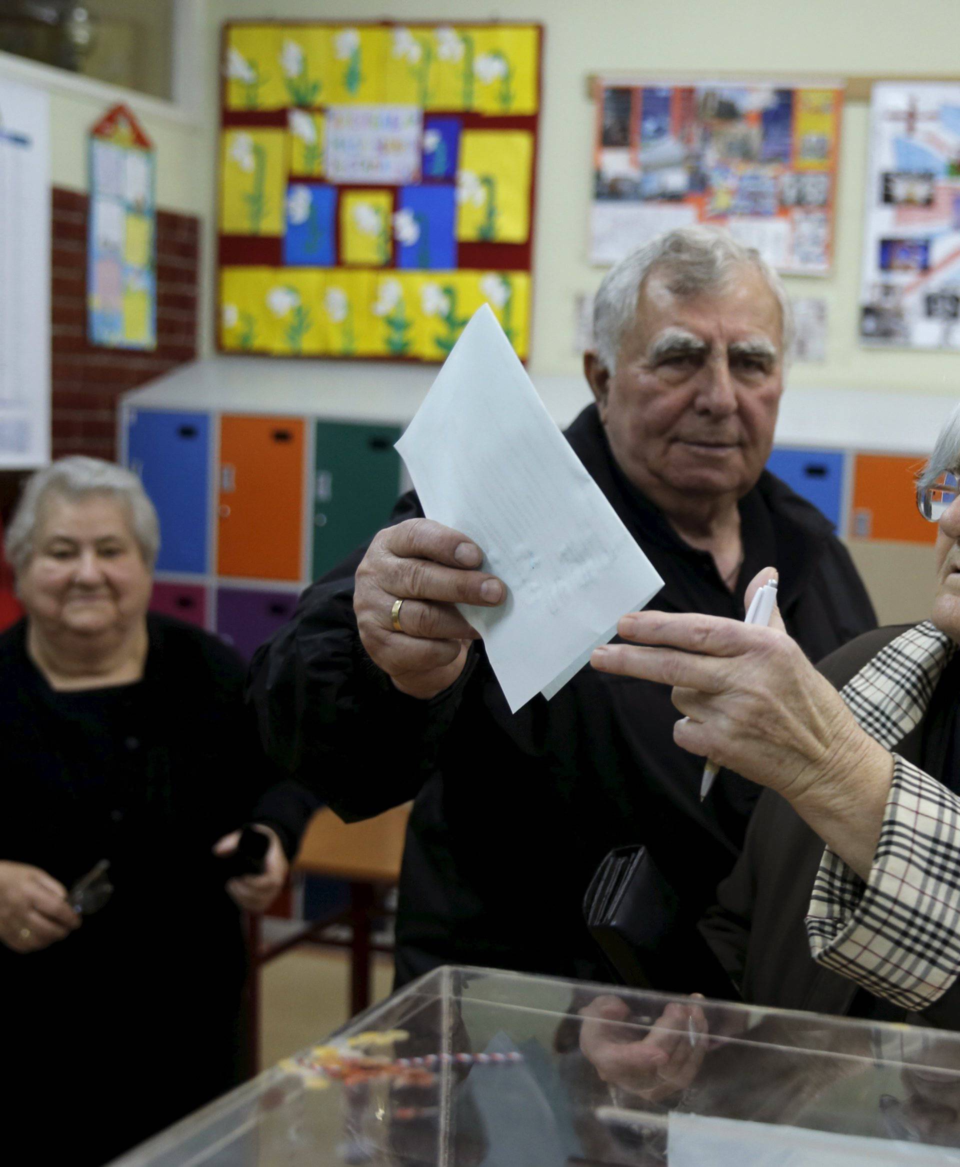People cast their votes at a polling station during elections in Belgrade