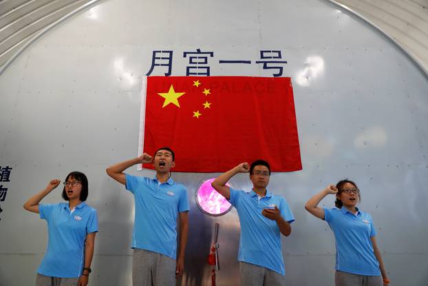 Volunteers take an oath before entering a simulated space cabin in which they will temporarily live as a part of the scientistic Lunar Palace 365 Project, at Beihang University in Beijing