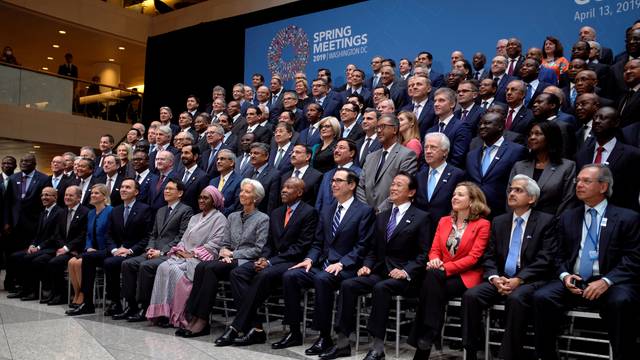 FILE PHOTO: Central bank governors and other global finance officials sit for a group photo at the IMF and World Bank's 2019 Annual Spring Meetings, in Washington