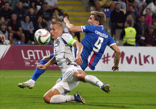 10.09.2024, Riga, Latvia. Kristers Tobers of Latvia, leftt, and Joan Edmundsson of Faroe Islands during their UEFA Natio