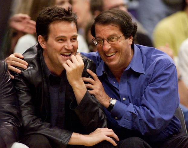 FILE PHOTO: Actor Matthew Perry (L) and studio executive Peter Roth attend Game One of the NBA Finals