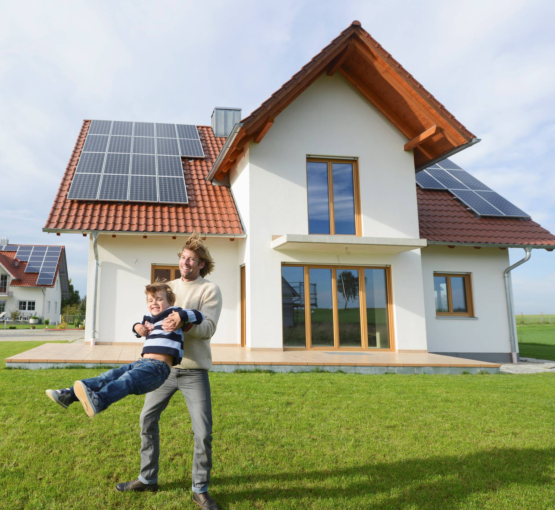 Mid adult man playing with son on lawn